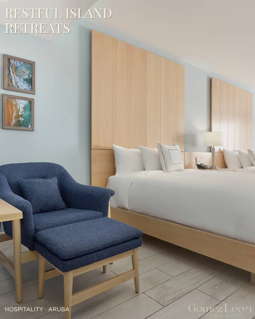 Hotel guest room at Courtyard by Marriott Aruba with a blue lounge chair and wood-paneled headboard